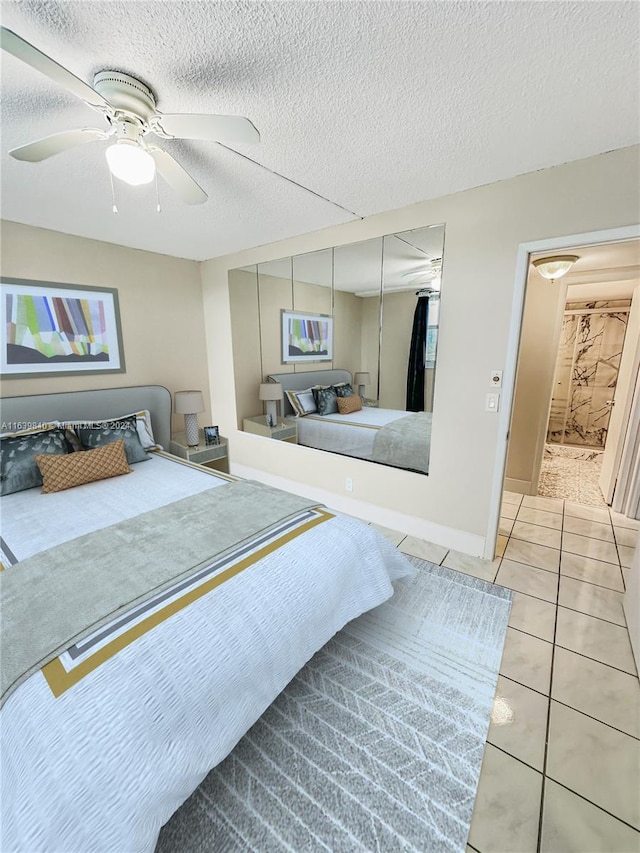 tiled bedroom featuring a textured ceiling, a closet, and ceiling fan