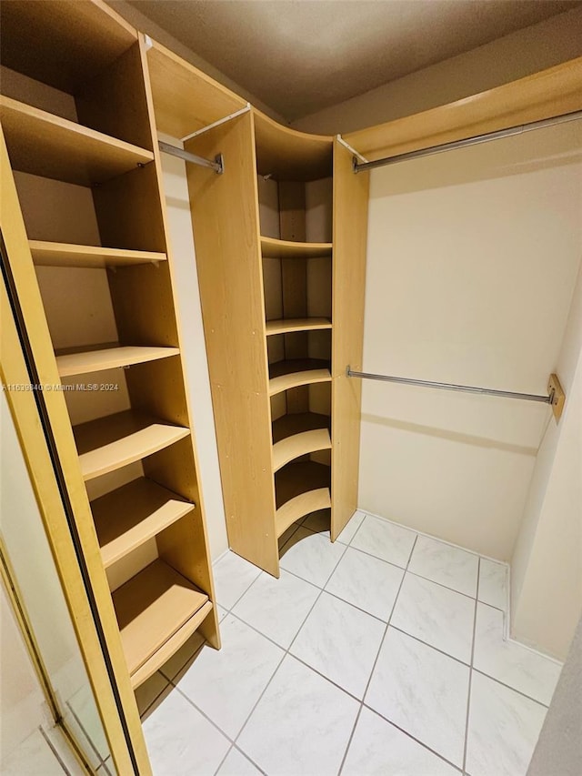 spacious closet with light tile patterned flooring