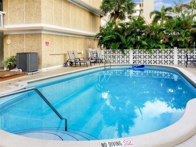 view of pool featuring cooling unit