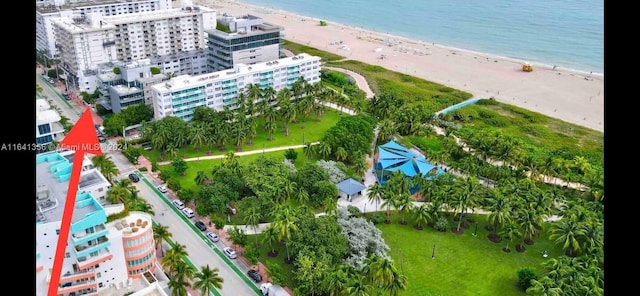 bird's eye view featuring a water view and a beach view