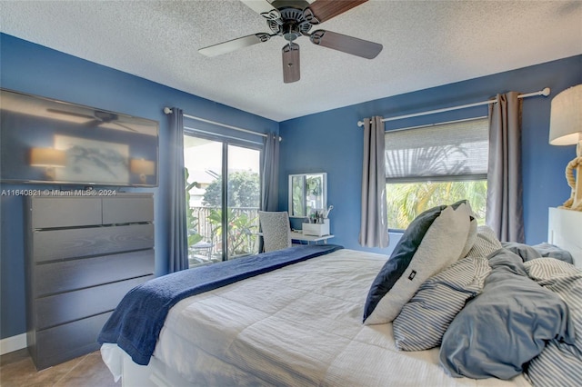 bedroom with tile patterned floors, ceiling fan, and a textured ceiling