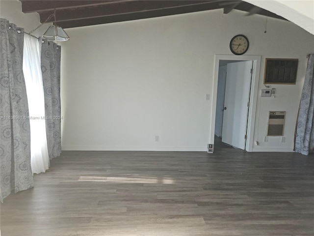 empty room with beam ceiling, high vaulted ceiling, and hardwood / wood-style flooring