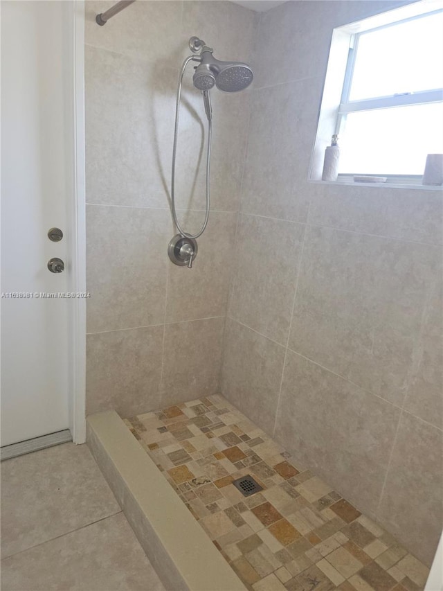 bathroom with a tile shower