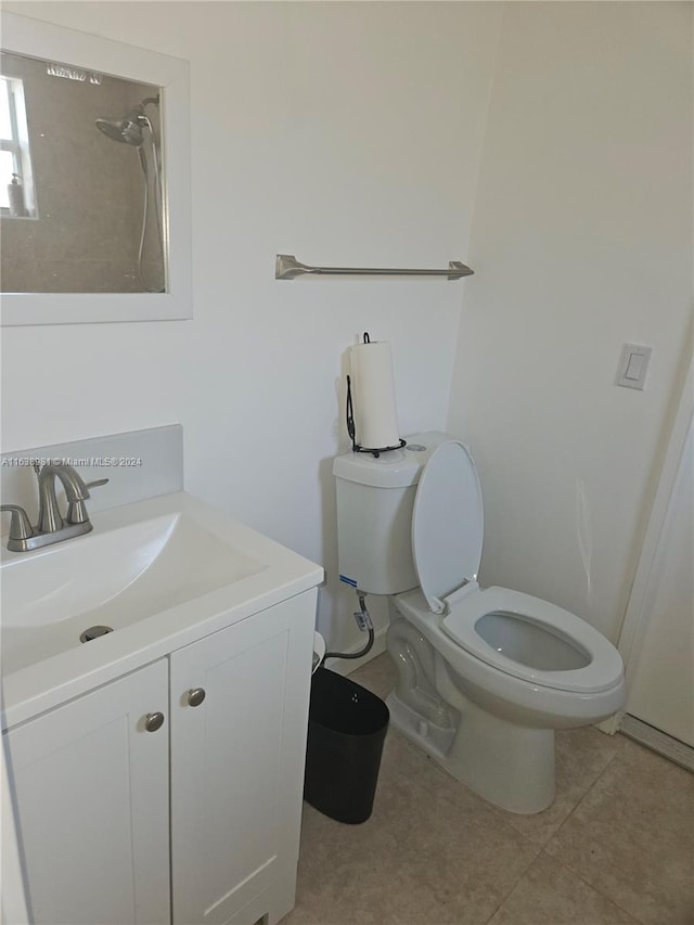 bathroom with vanity, toilet, and tile patterned flooring