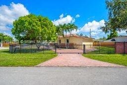 view of gate featuring a yard