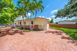 view of side of property featuring a patio area