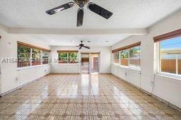 interior space with ceiling fan