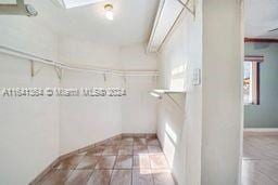 spacious closet featuring light tile patterned flooring