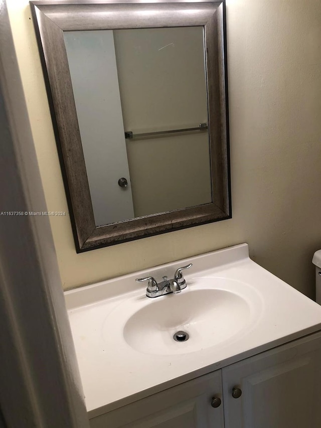 bathroom with toilet and vanity