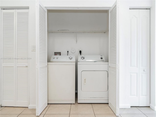 laundry area with light tile patterned floors and separate washer and dryer