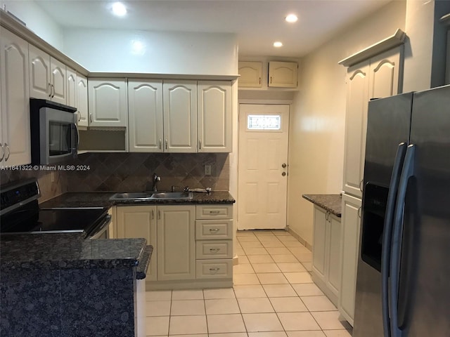 kitchen featuring sink, light tile patterned floors, backsplash, and stainless steel appliances