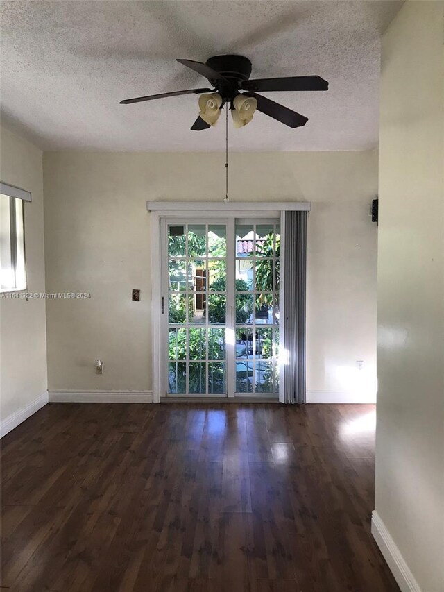 empty room featuring a textured ceiling, ceiling fan, and hardwood / wood-style floors