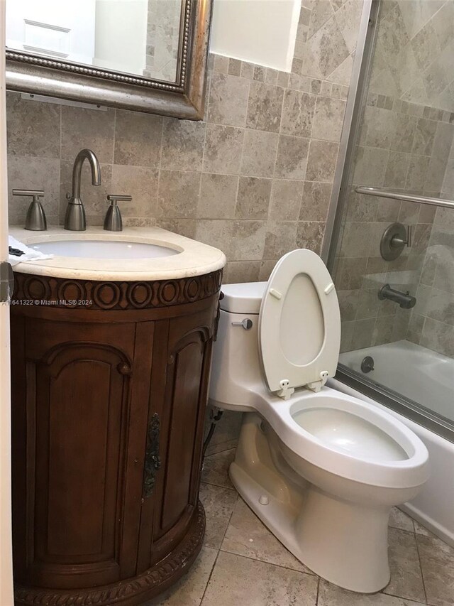 full bathroom with tile walls, tasteful backsplash, vanity, and toilet