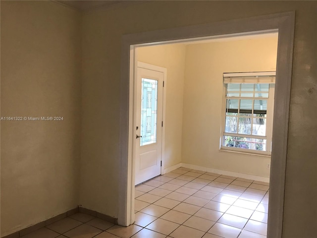 doorway featuring plenty of natural light and light tile patterned floors