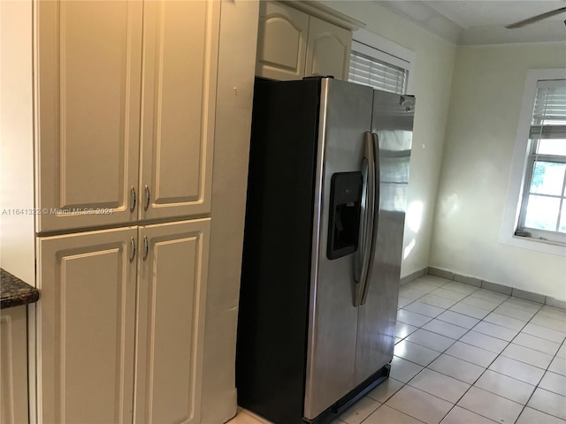 kitchen with stainless steel fridge and light tile patterned floors