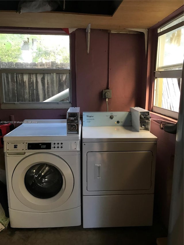 laundry room featuring separate washer and dryer and a healthy amount of sunlight