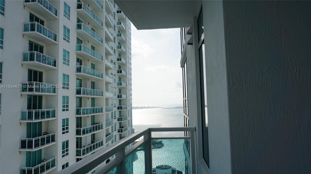 balcony featuring a water view