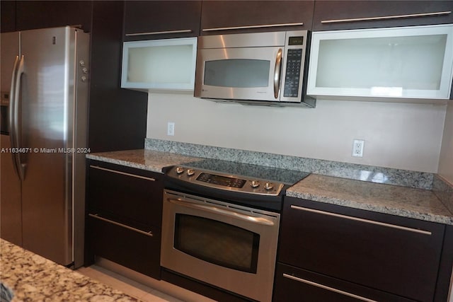 kitchen featuring light stone countertops and stainless steel appliances