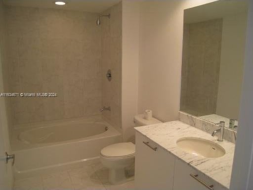 full bathroom with toilet, tiled shower / bath combo, tile patterned floors, and vanity