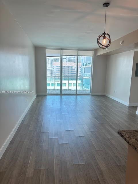 spare room featuring dark wood-type flooring and floor to ceiling windows