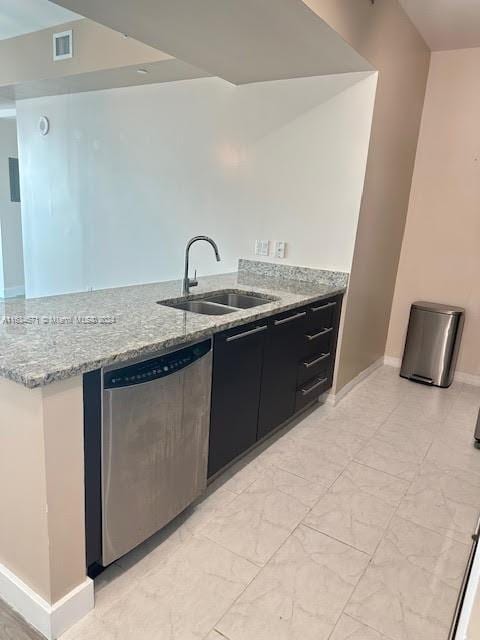 kitchen with dishwasher, sink, light stone counters, and light tile patterned floors