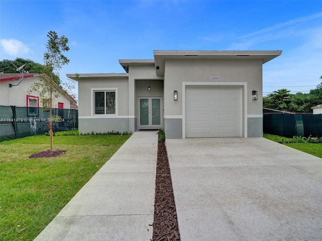 view of front facade featuring a front yard and a garage