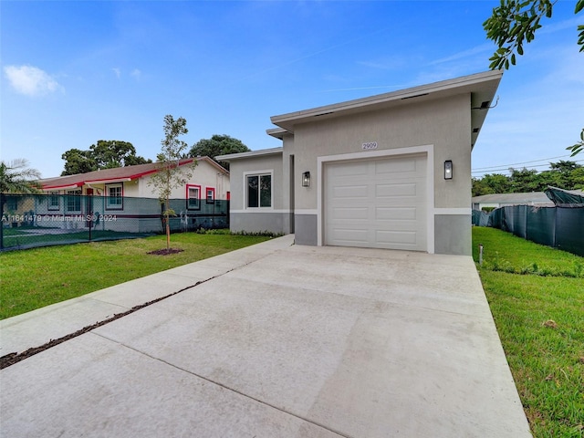 view of front of property with a garage and a front lawn