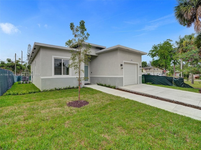 single story home featuring a front lawn and a garage