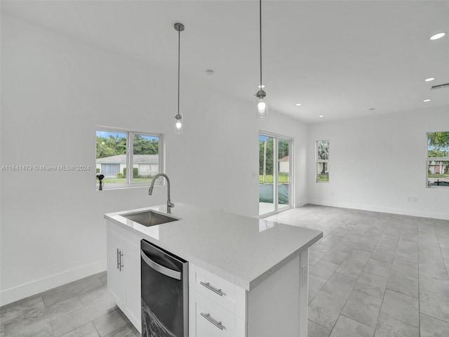 kitchen with white cabinetry, a kitchen island with sink, hanging light fixtures, light tile patterned floors, and sink