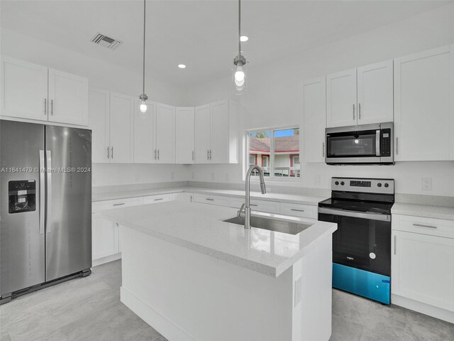 kitchen with sink, stainless steel appliances, an island with sink, and white cabinetry