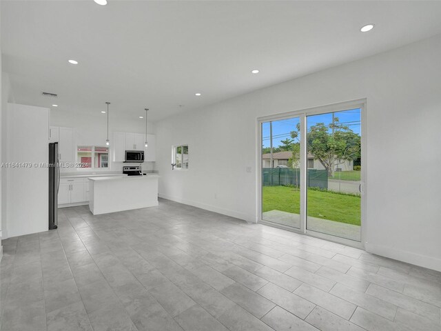 unfurnished living room with light tile patterned floors