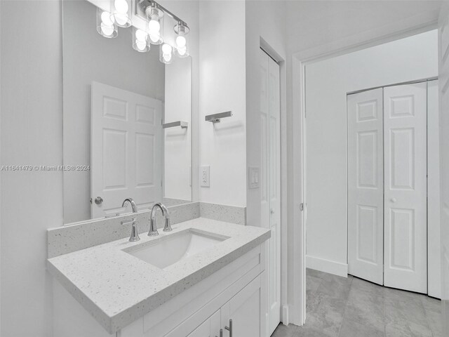 bathroom with tile patterned floors and vanity