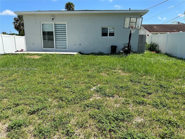 rear view of house with a yard