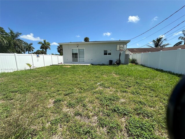 back of property featuring a lawn