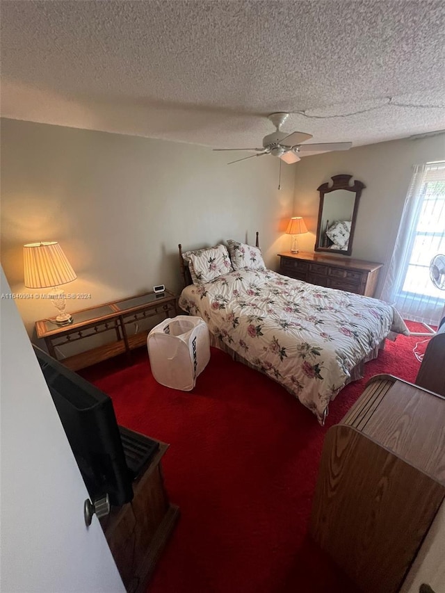 carpeted bedroom with a textured ceiling and ceiling fan