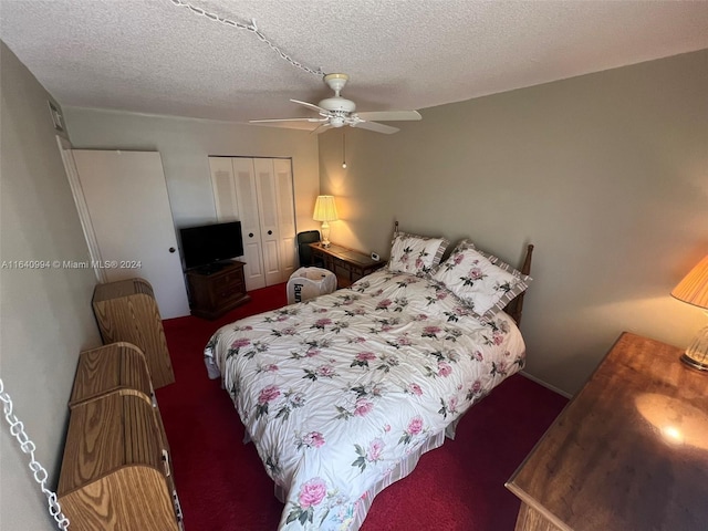 bedroom featuring dark colored carpet, a closet, ceiling fan, and a textured ceiling