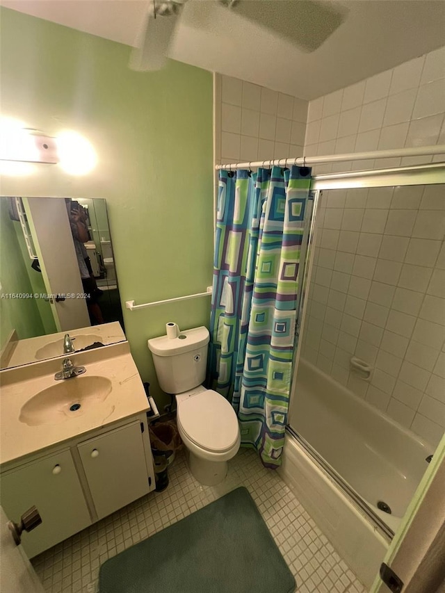 bathroom with shower / bath combo, vanity, toilet, and tile patterned floors