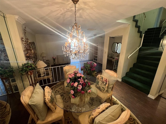 dining area featuring baseboards, ornamental molding, wood finished floors, stairs, and a chandelier