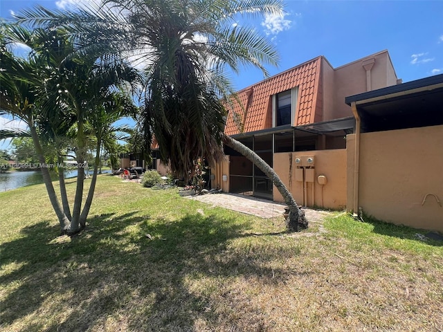 view of yard with a patio and a water view