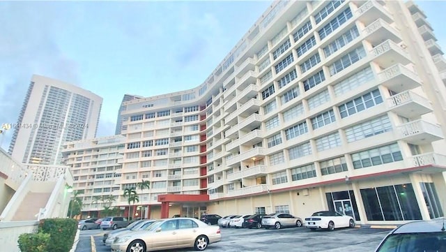 view of building exterior featuring uncovered parking