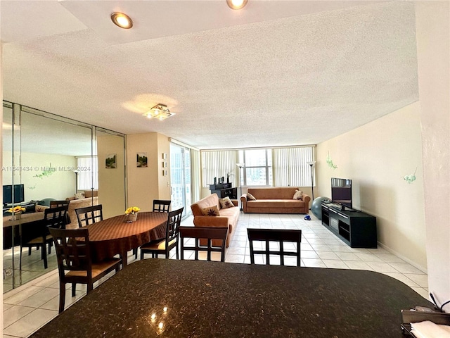 tiled dining area with a textured ceiling