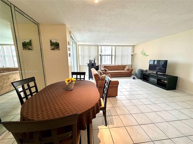 dining space with light tile patterned flooring and a textured ceiling