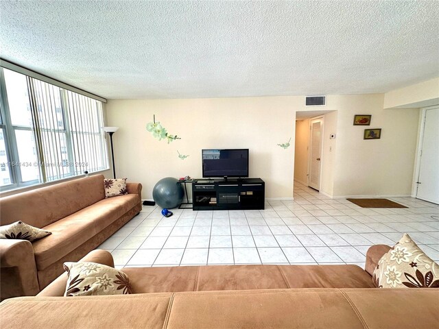 living room with light tile patterned flooring and a textured ceiling