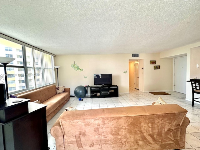 tiled living room featuring a textured ceiling