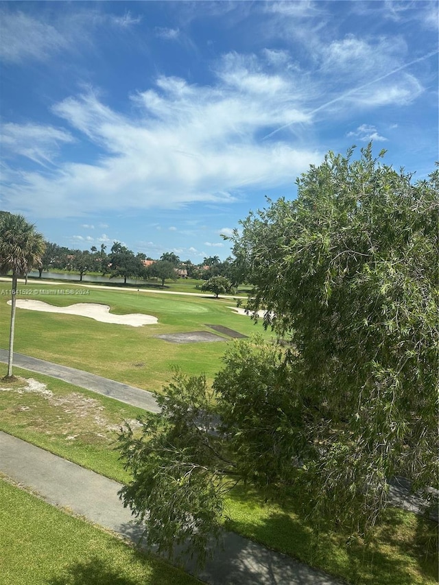 view of home's community with a yard and golf course view