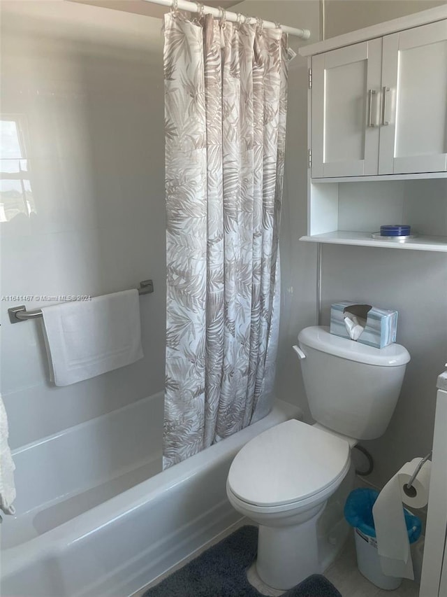 bathroom with shower / tub combo and toilet