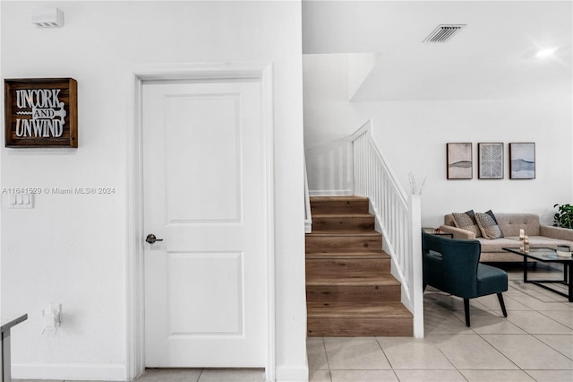 stairway with tile patterned floors