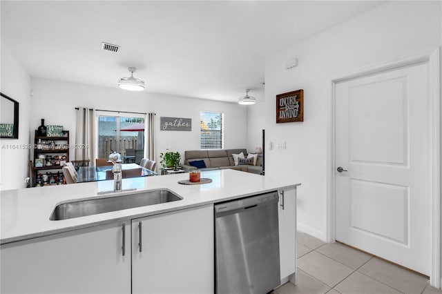 kitchen featuring sink, light tile patterned flooring, and stainless steel dishwasher