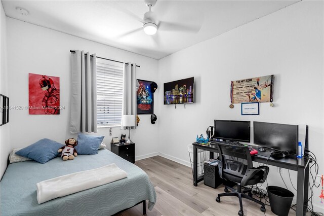 bedroom with ceiling fan and light hardwood / wood-style floors