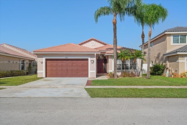 mediterranean / spanish house with a garage and a front lawn